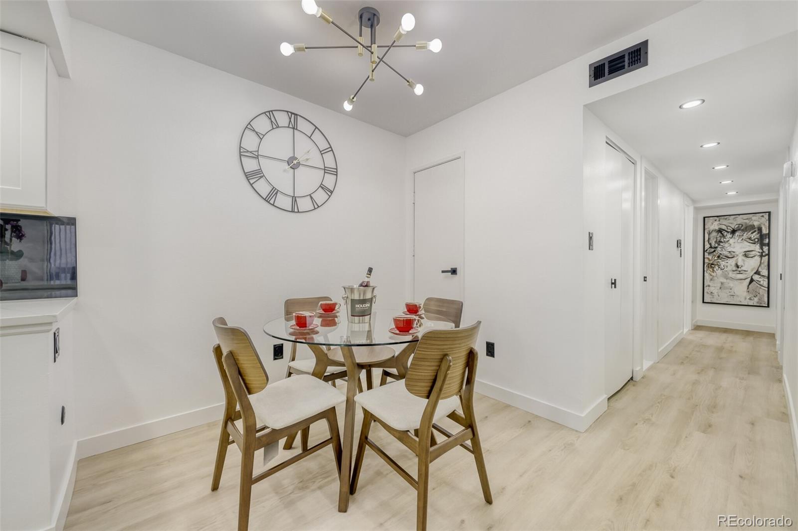 4400 South Quebec Street, Unit 106W Denver, CO 80237 - Photo 7 of 17 a view of a dining room with furniture and a chandelier