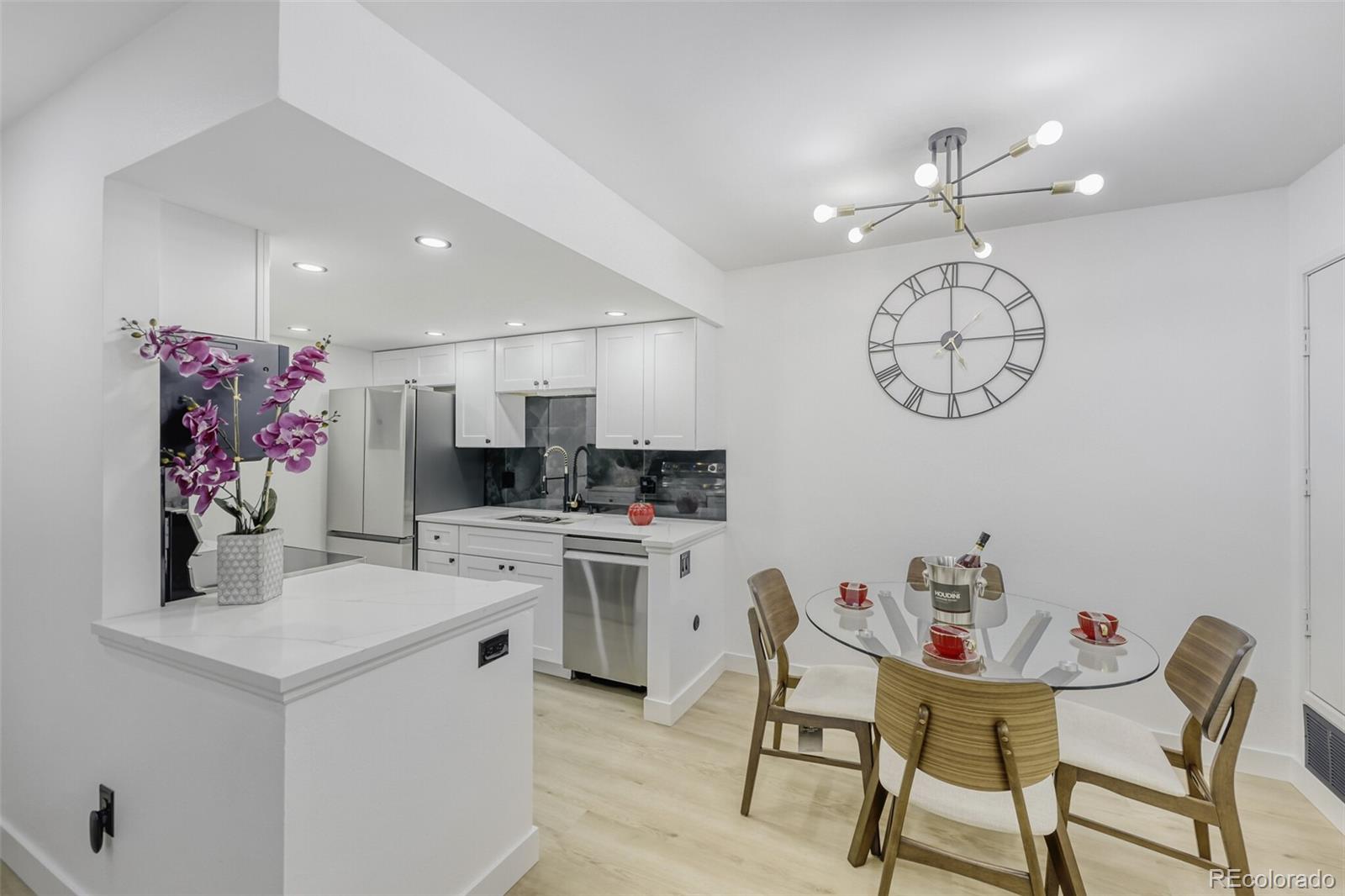 4400 South Quebec Street, Unit 106W Denver, CO 80237 - Photo 9 of 17 a view of kitchen and dining area with furniture