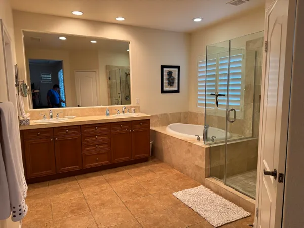 a bathroom with a tub sink and mirror