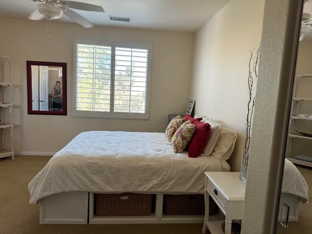 a bedroom with a bed and window