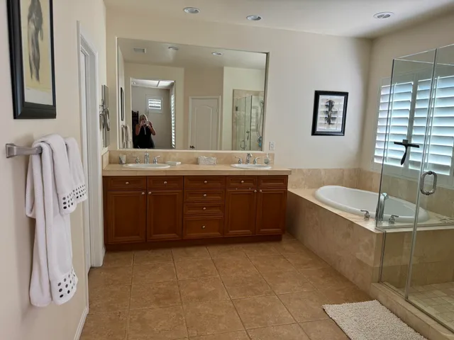 a spacious bathroom with a tub sink and mirror