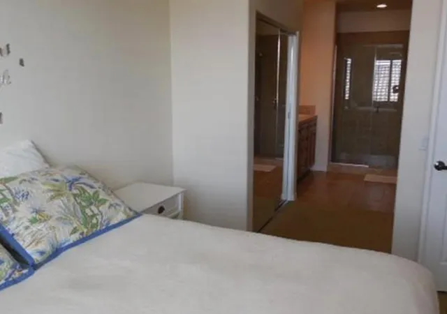 a bedroom with a bed and lamp