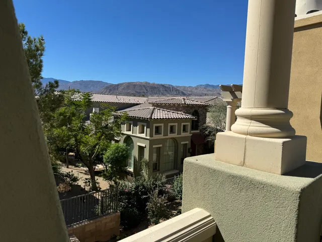 a view of a balcony with next to a yard