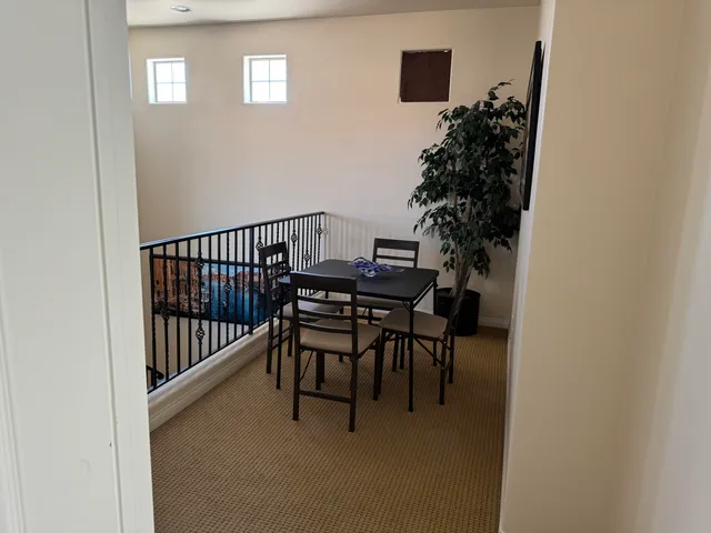 a view of a porch with a table and chairs