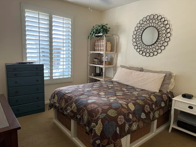 a bedroom with a bed and a window