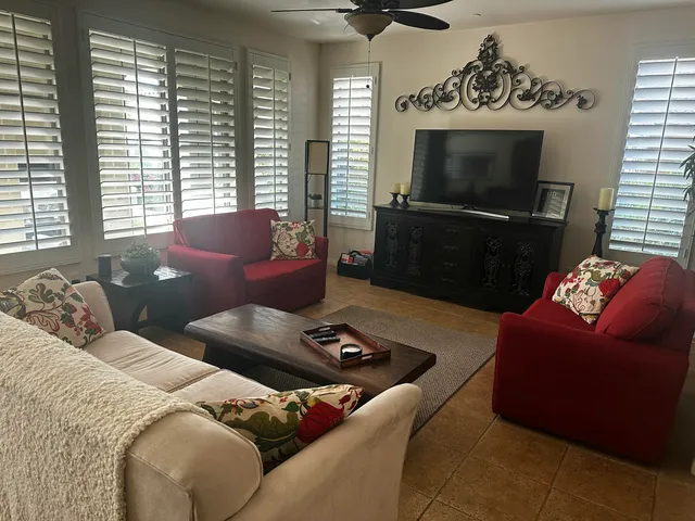 a living room with furniture a flat screen tv and a fireplace