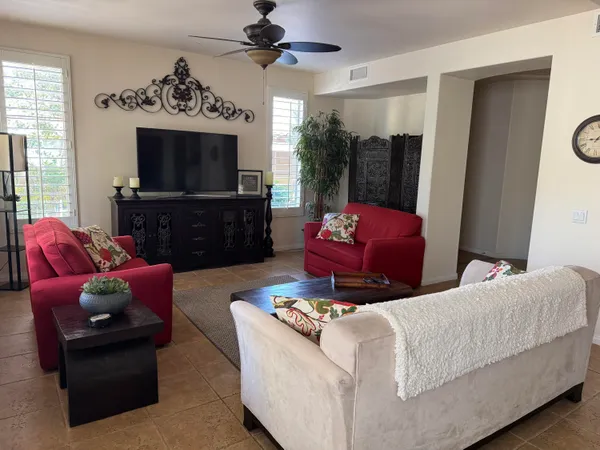 a living room with furniture a flat screen tv and a fireplace