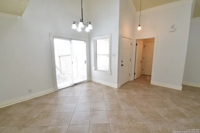 a view of a hallway with chandelier and entryway