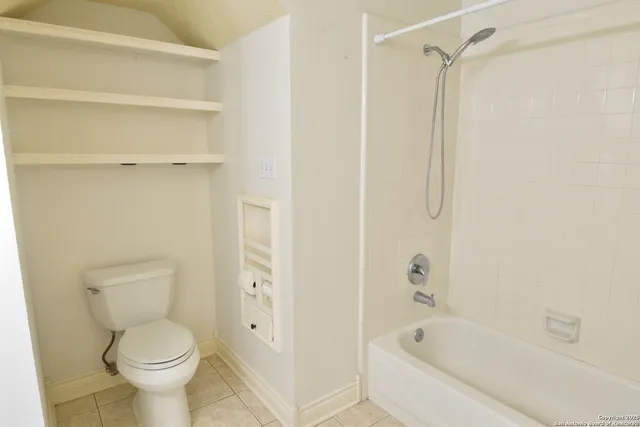 a bathroom with a toilet and a bathtub