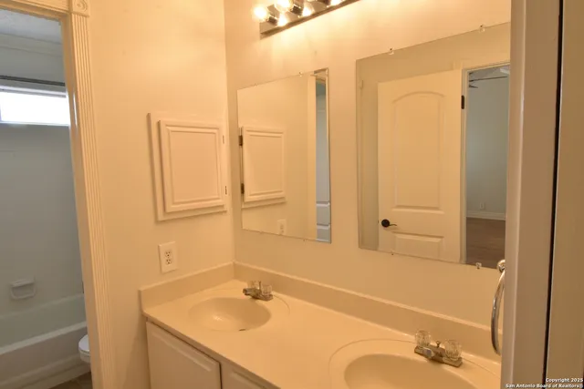 a bathroom with a bathtub and a sink