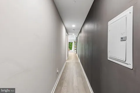 a view of a hallway with wooden shelves