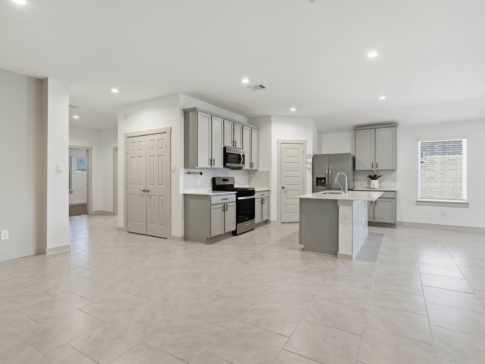 29903 Violet Sky Way Katy, TX 77494 - Photo 13 of 38 a kitchen with stainless steel appliances a refrigerator sink and microwave