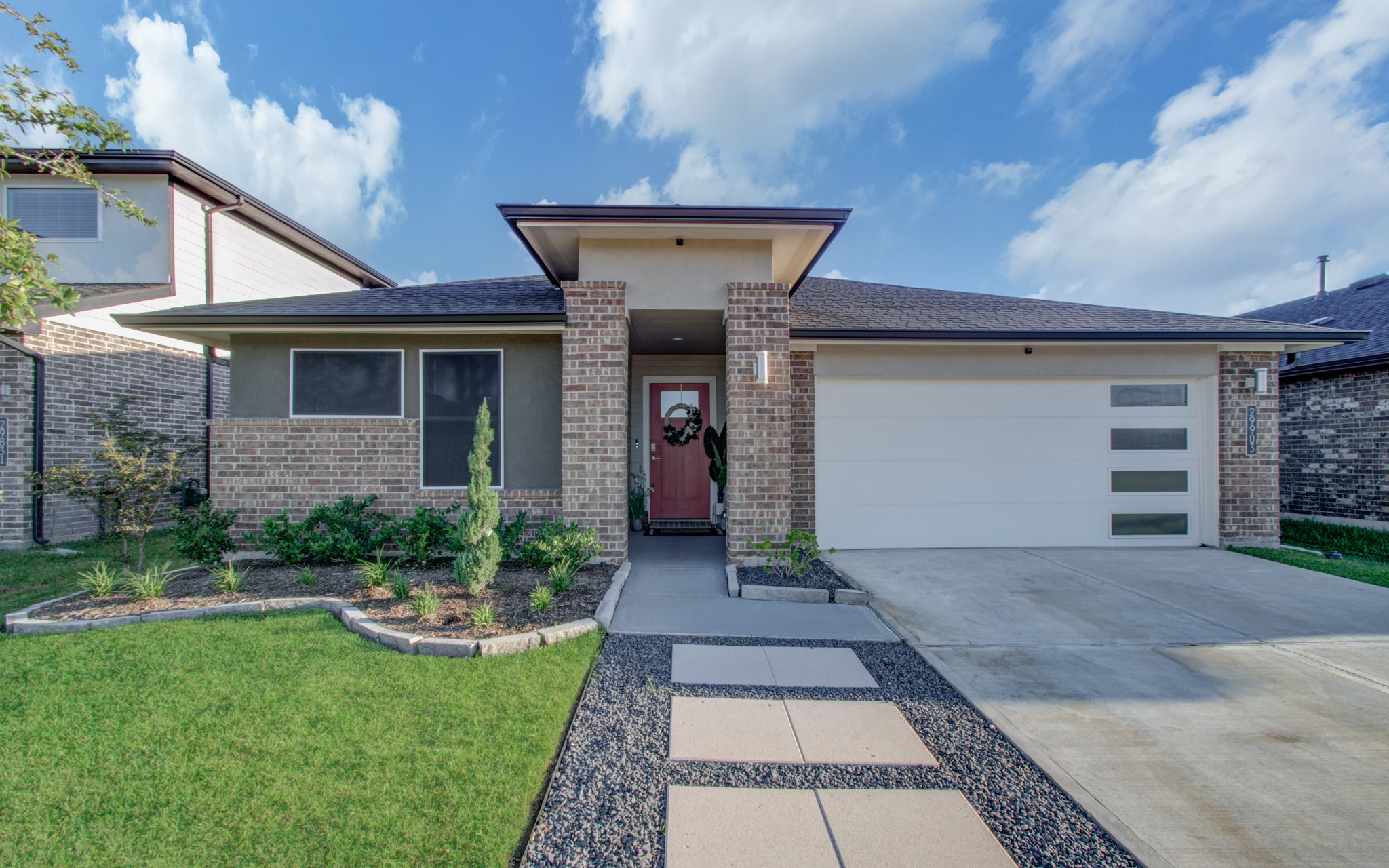 29903 Violet Sky Way Katy, TX 77494 - Photo 2 of 38 a front view of a house with garden and plants
