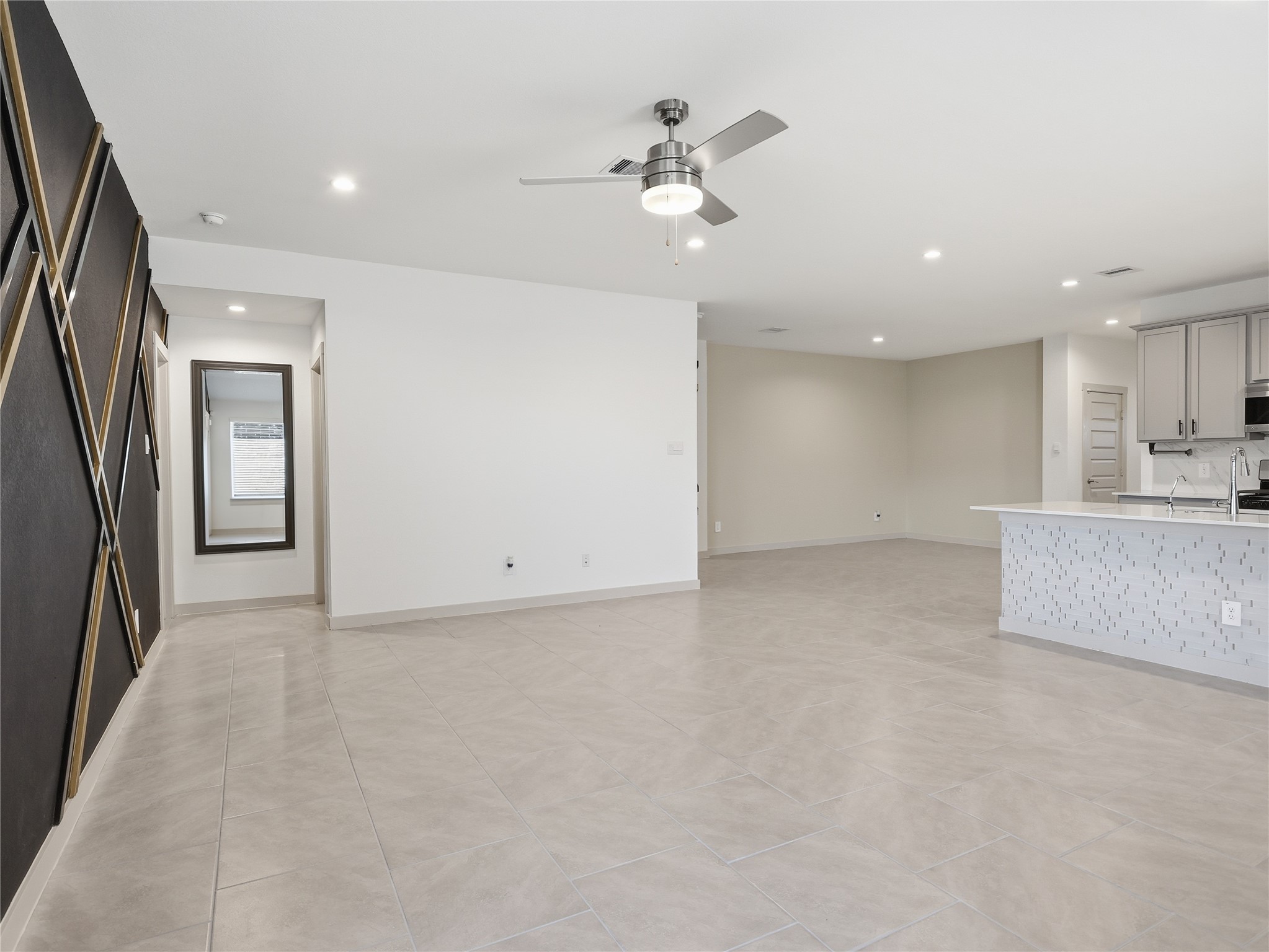 29903 Violet Sky Way Katy, TX 77494 - Photo 22 of 38 an empty room with a ceiling fan and hallway