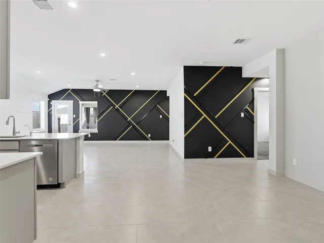 a room with wooden floor and white walls