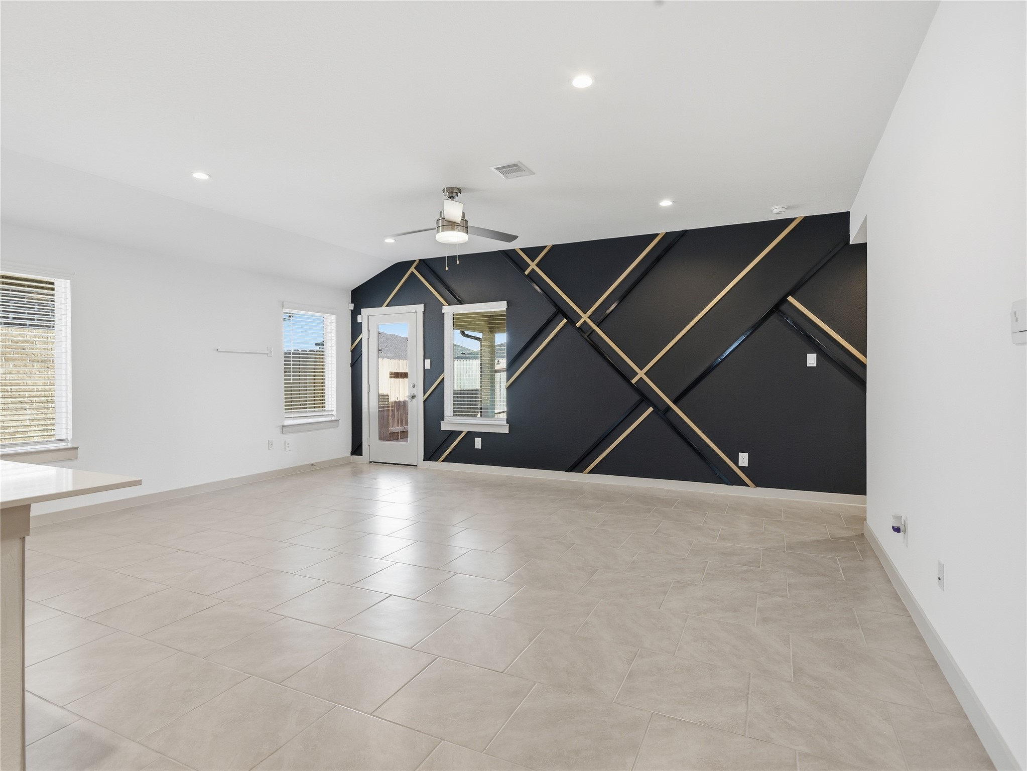 29903 Violet Sky Way Katy, TX 77494 - Photo 9 of 38 an empty room with windows and fan