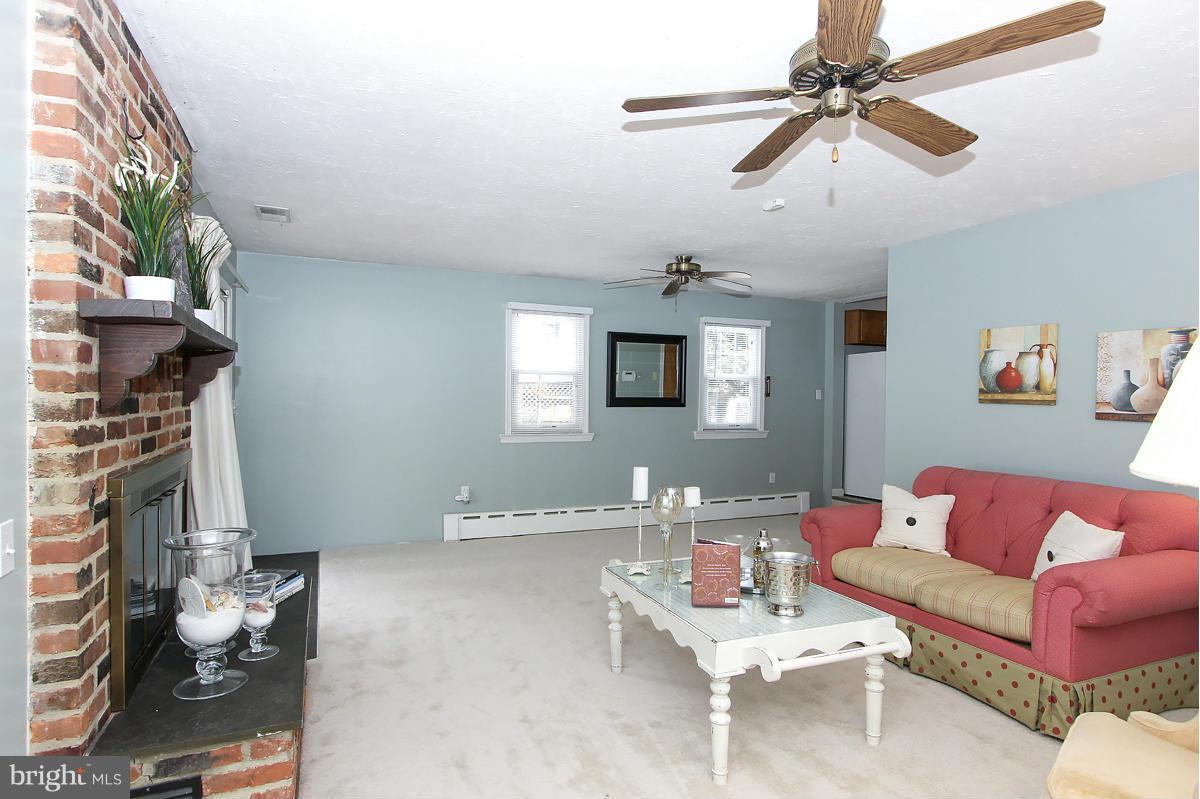 1919 Grace Church Road Silver Spring, MD 20910 - Photo 14 of 23 a living room with furniture and a fireplace