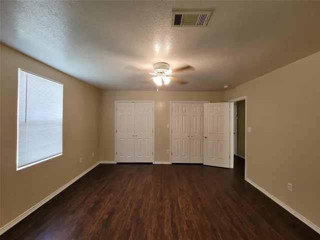 an empty room with wooden floor