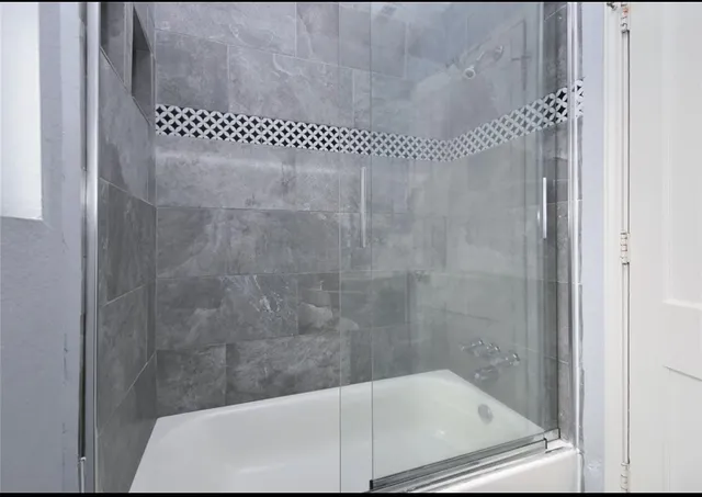 a bathroom with a glass shower door