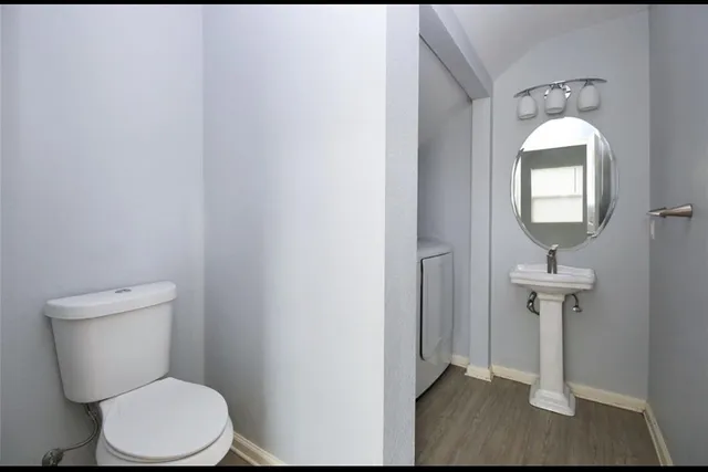 a white toilet sitting next to a bathroom sink