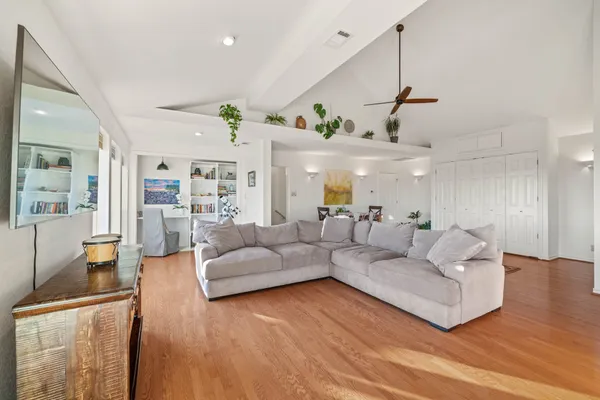 a living room with furniture and wooden floor
