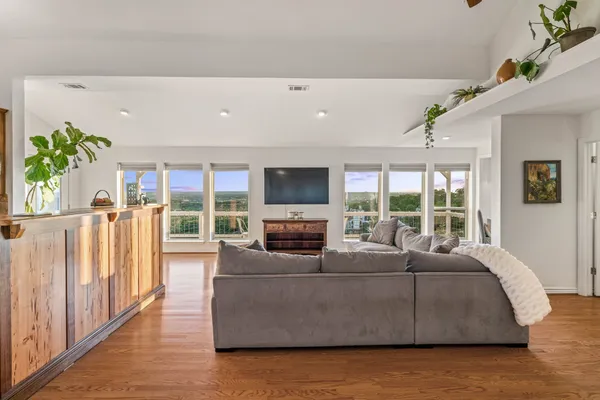 a living room with furniture fireplace and a large window
