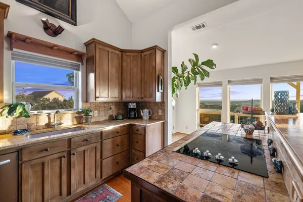 a kitchen with a stove a sink and cabinets