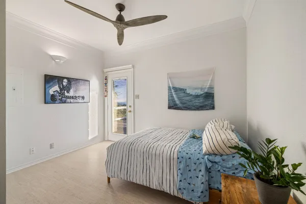a bedroom with a bed and a painting on the wall