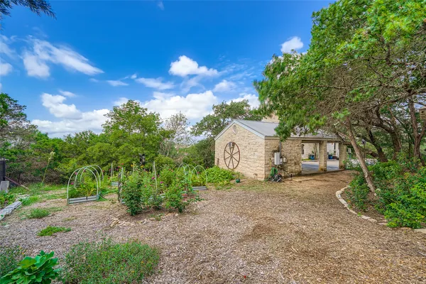 a view of a house with a tree in the background