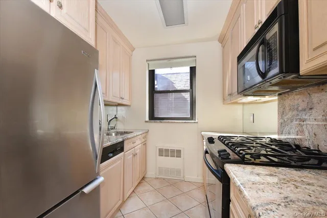 a kitchen with stainless steel appliances a stove a sink and a refrigerator