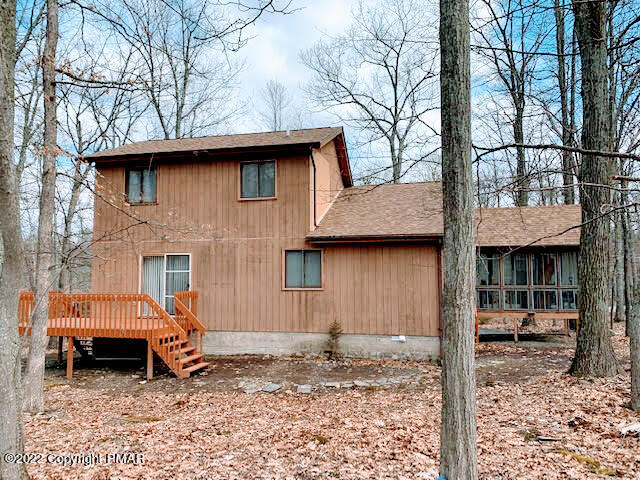 139 Dunchurch Drive Bushkill, PA 18324 - Photo 2 of 12 a backyard of a house with barbeque oven table and chairs