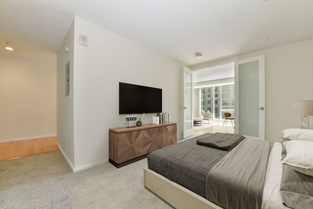 2 Earhart Street, Unit 324 Cambridge, MA 02141 - Photo 12 of 42 a bedroom with a bed and a flat screen tv