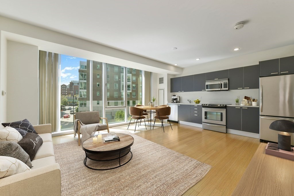 2 Earhart Street, Unit 324 Cambridge, MA 02141 - Photo 3 of 42 a living room with furniture and a large window