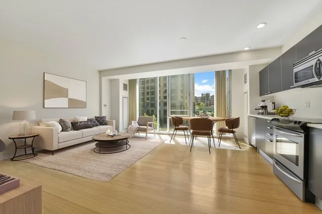 a living room with fireplace furniture and a large window