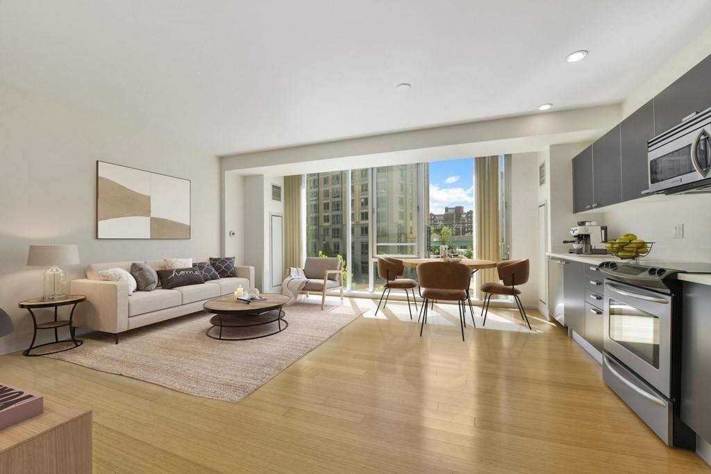2 Earhart Street, Unit 324 Cambridge, MA 02141 - Photo 8 of 42 a living room with fireplace furniture and a large window
