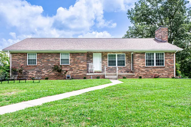 a view of a house with a backyard