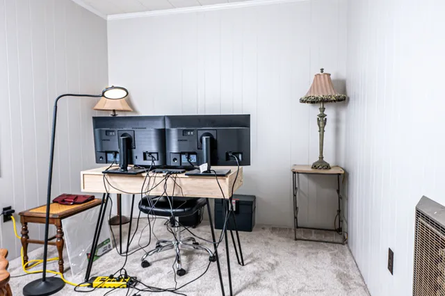 a view of a dining room with furniture and a chandelier
