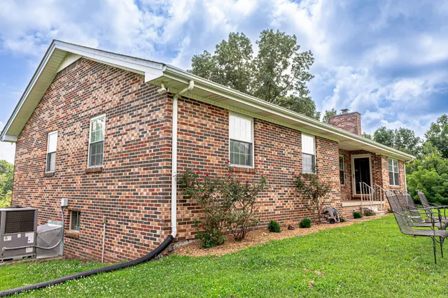 a view of house with backyard