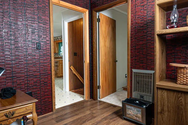 a view of a livingroom with wooden floor and staircase