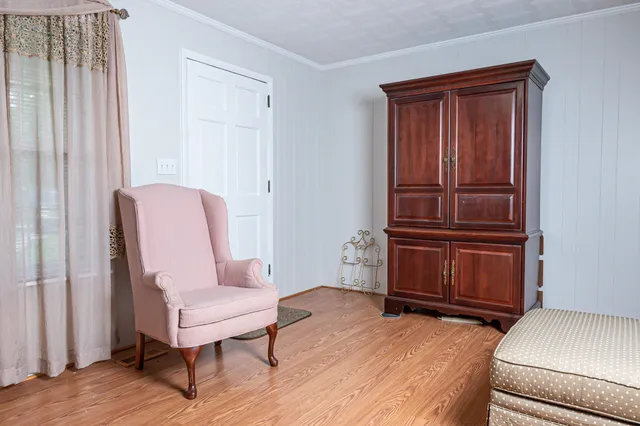 a living room with furniture and a dresser