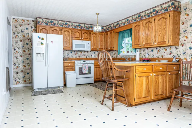a dining room with furniture a window and appliances