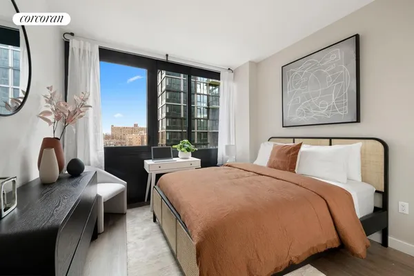 a bedroom with double bed and a window