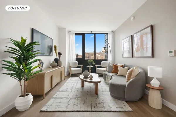 a living room with furniture and a potted plant