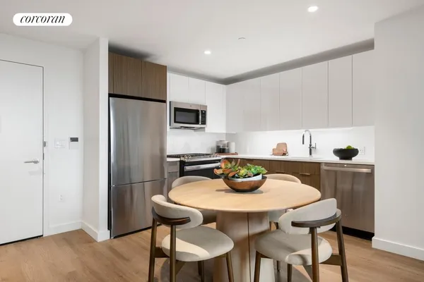 a kitchen with a dining table and chairs