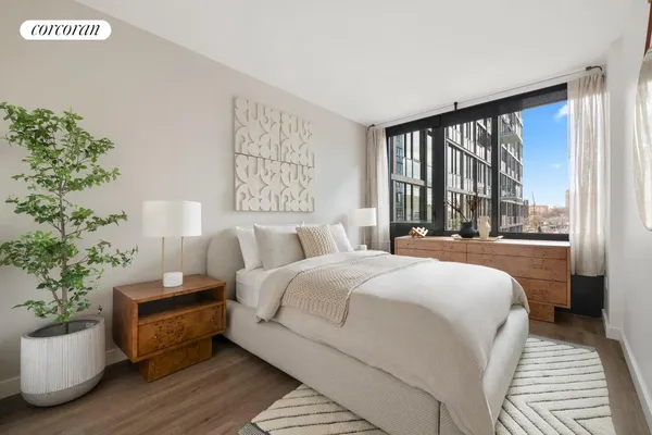 a bedroom with a bed and a potted plant
