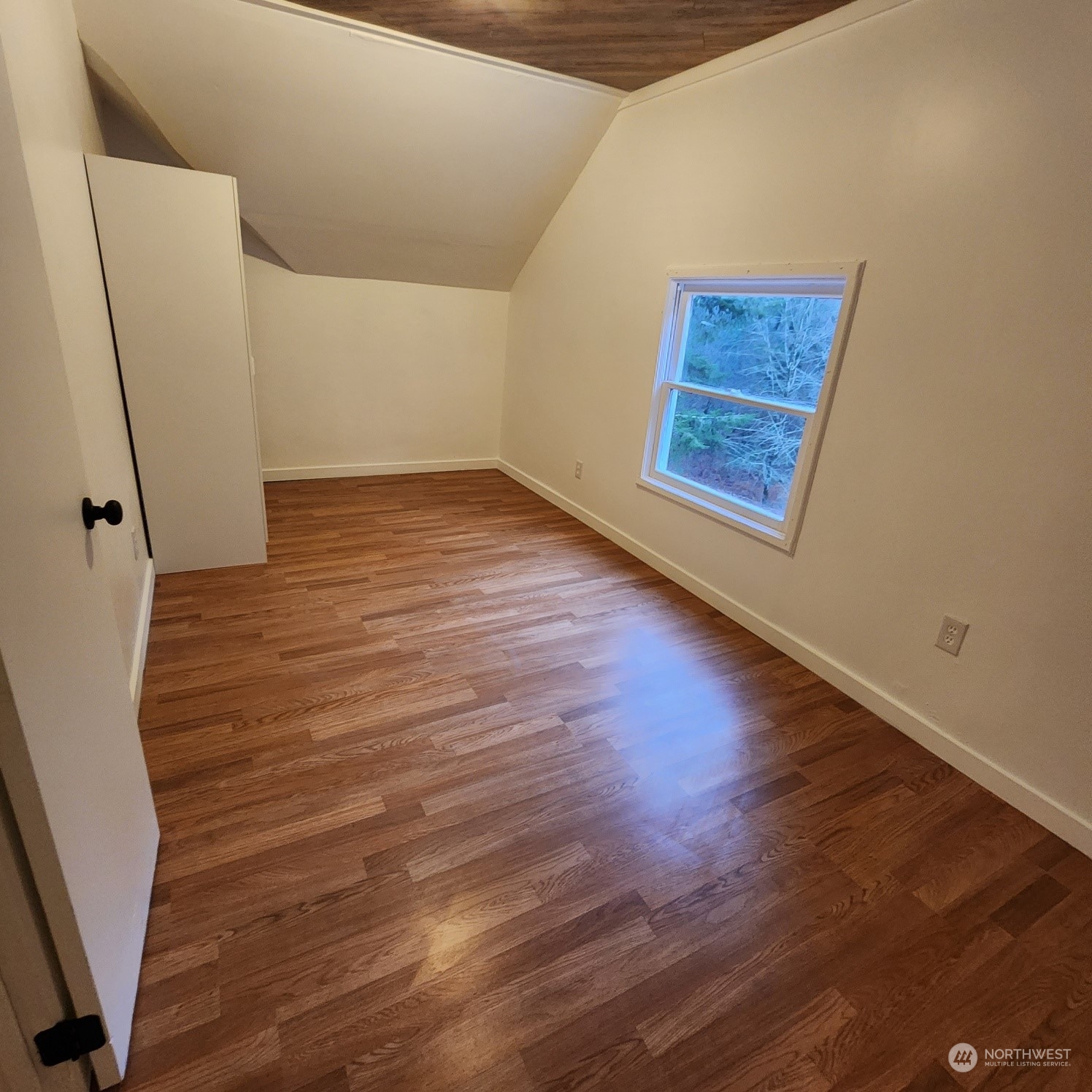 62 Kin Road Naselle, WA 98638 - Photo 15 of 20 a view of an empty room with wooden floor and a window