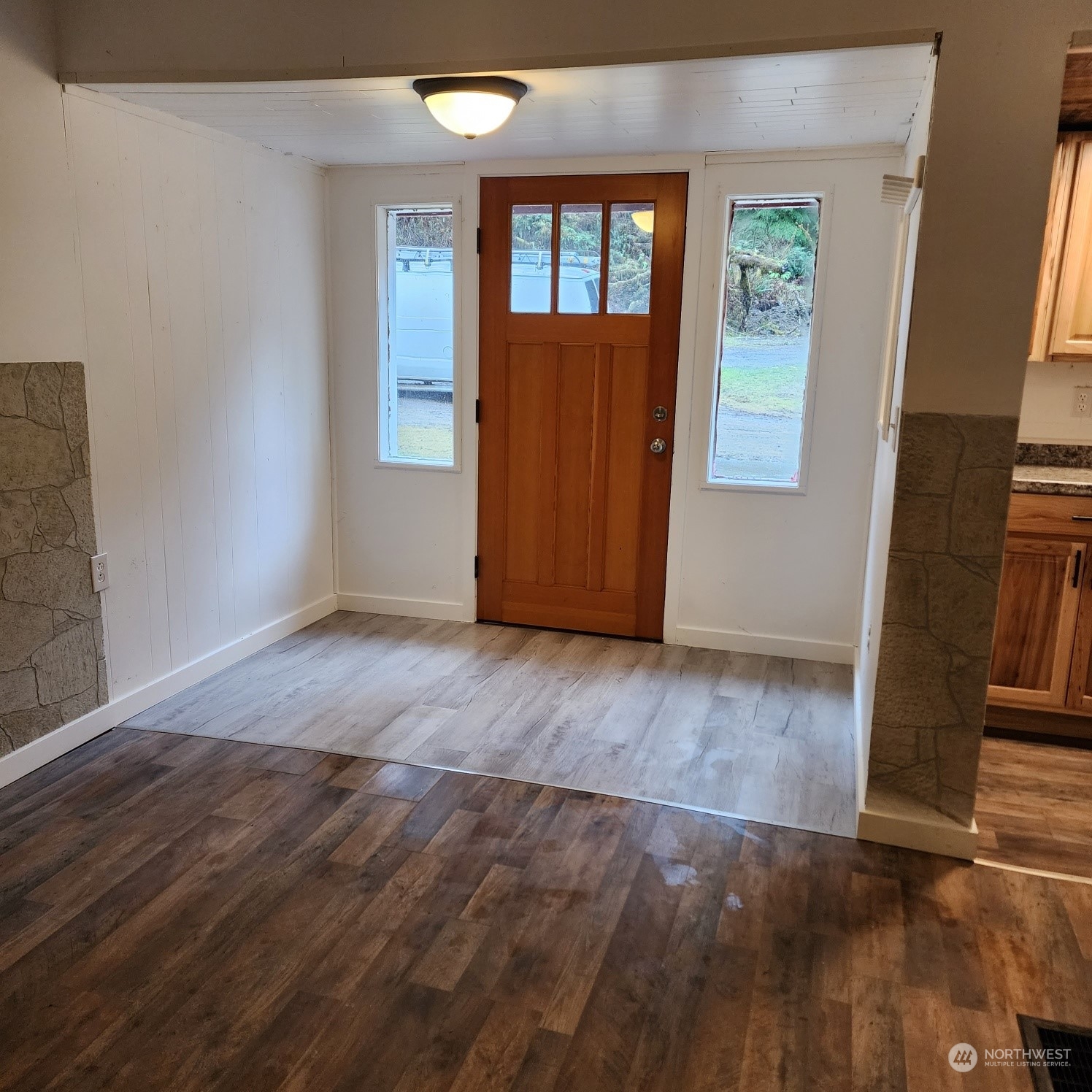 62 Kin Road Naselle, WA 98638 - Photo 2 of 20 an empty room with wooden floor and windows