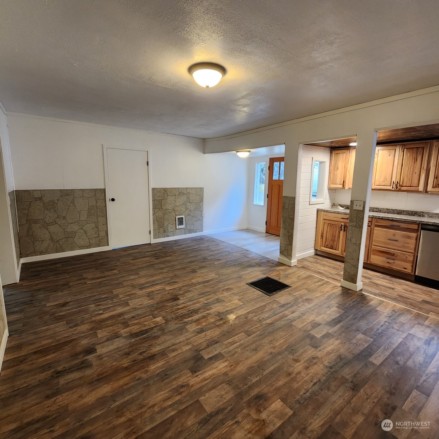 62 Kin Road Naselle, WA 98638 - Photo 4 of 20 wooden floor in an empty room with a fireplace