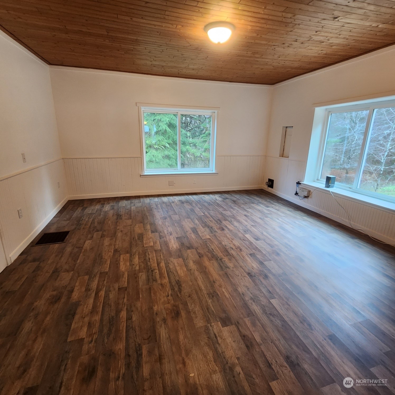 62 Kin Road Naselle, WA 98638 - Photo 7 of 20 an empty room with wooden floor and windows