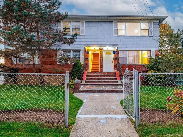 a front view of a house with a yard